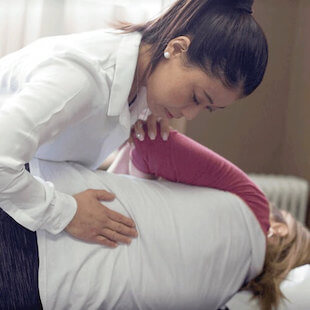 Karen Ngo chiropractic lower back treatment on patient